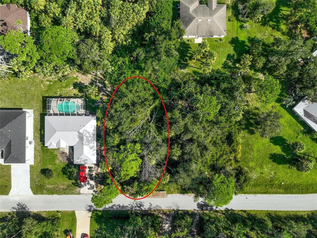 an aerial view of a house with a yard and garden