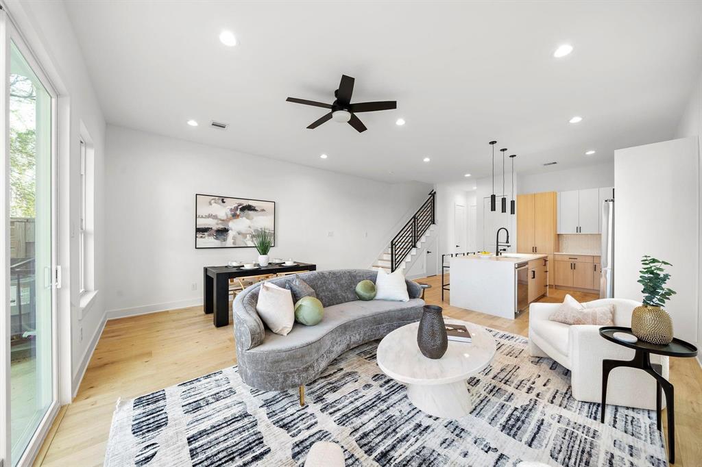 a living room with furniture and kitchen view