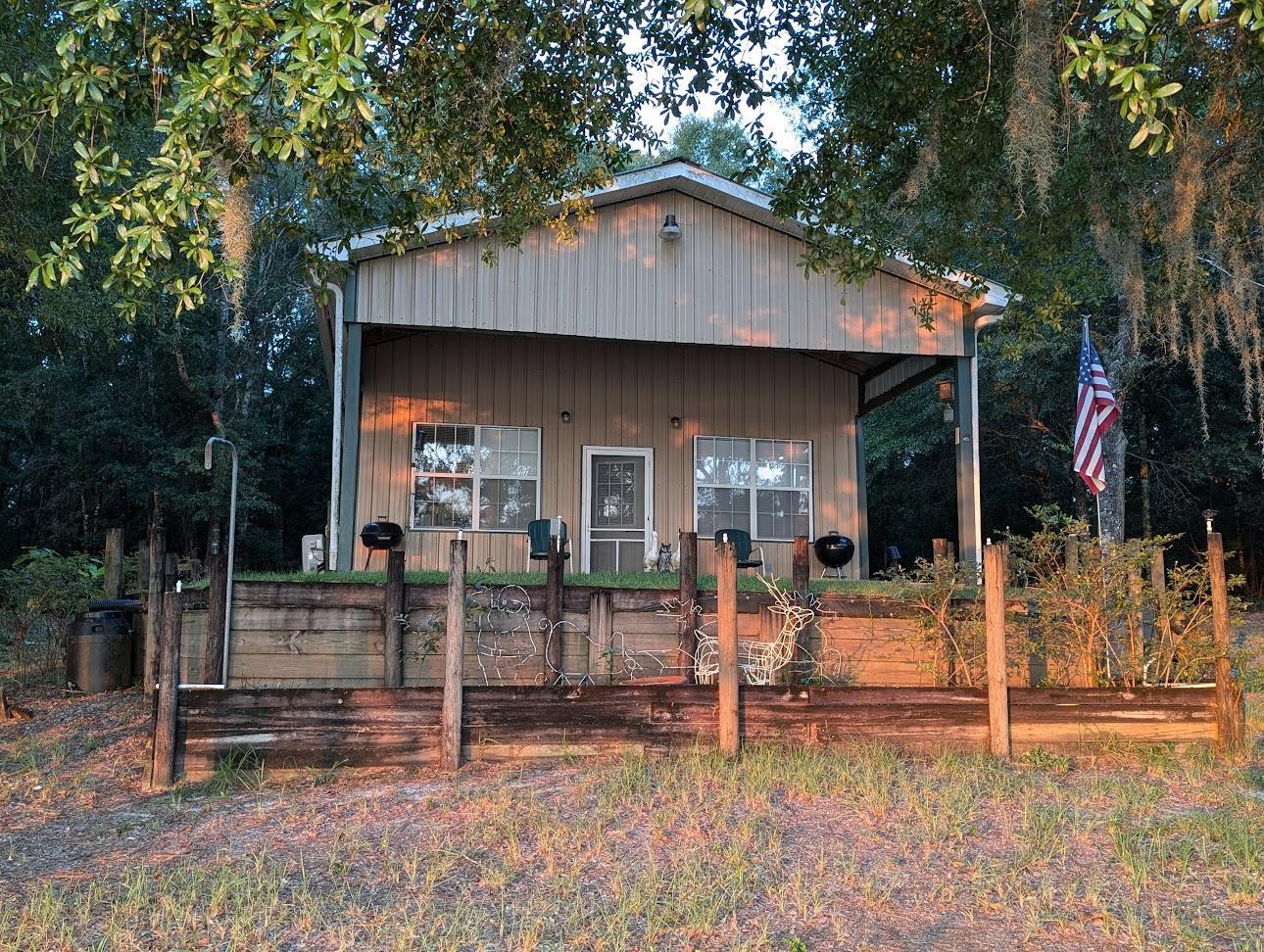 a view of a house with wooden fence and large windows