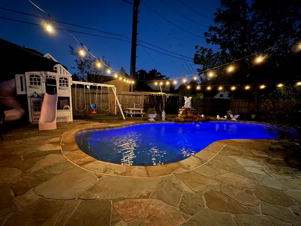 a view of a swimming pool with an outdoor seating