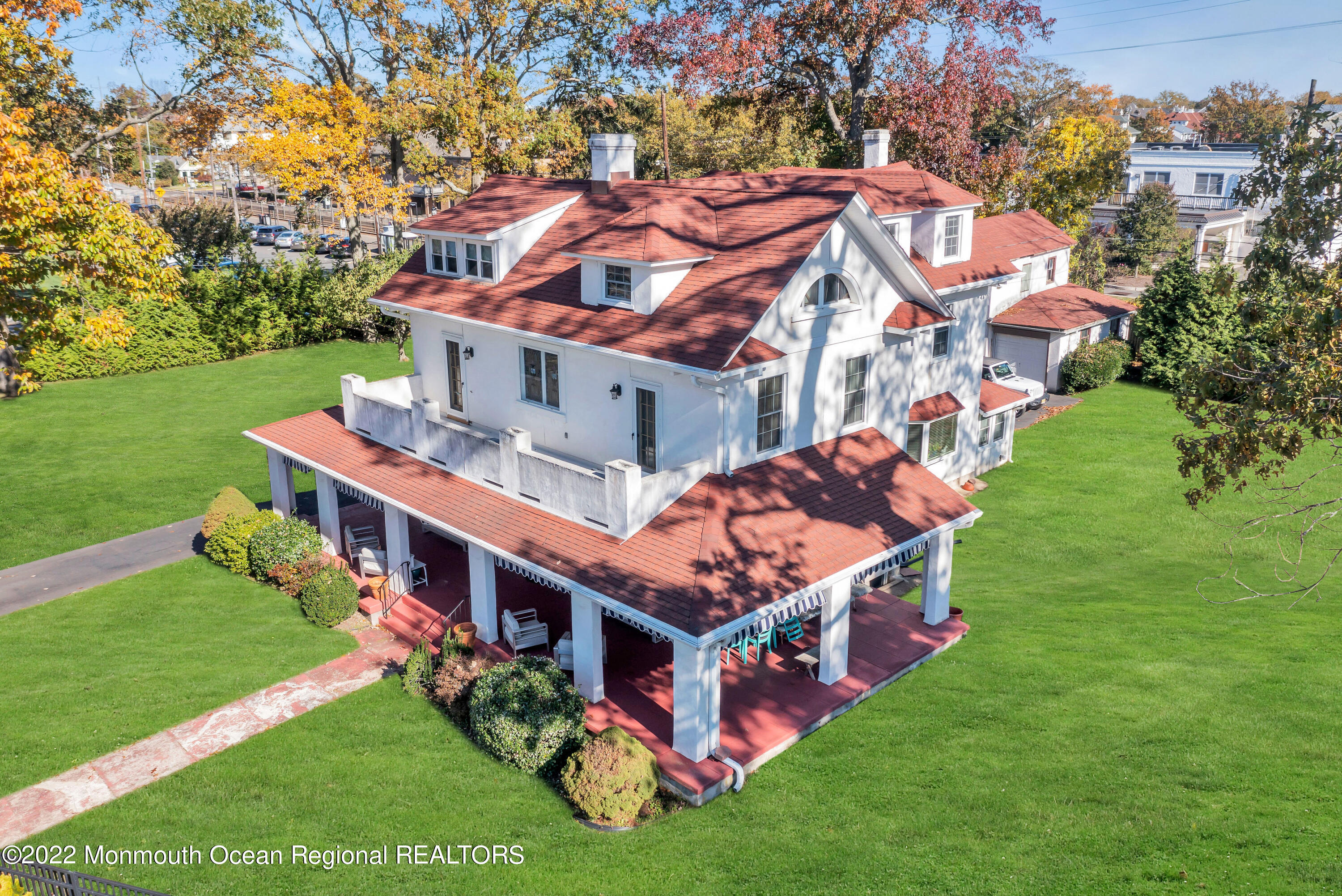 a aerial view of a house with a big yard potted plants and large tree