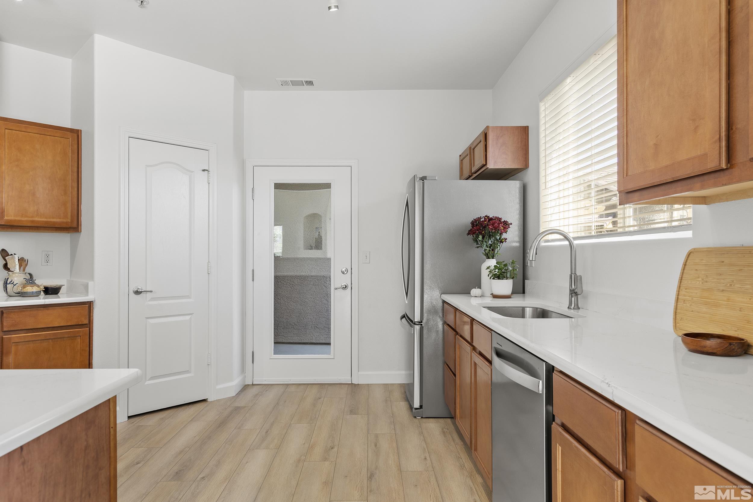 a kitchen with a sink cabinets and wooden floor