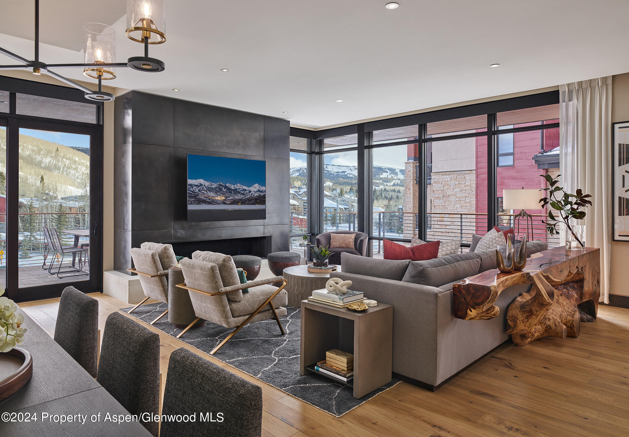 a living room with furniture and floor to ceiling windows