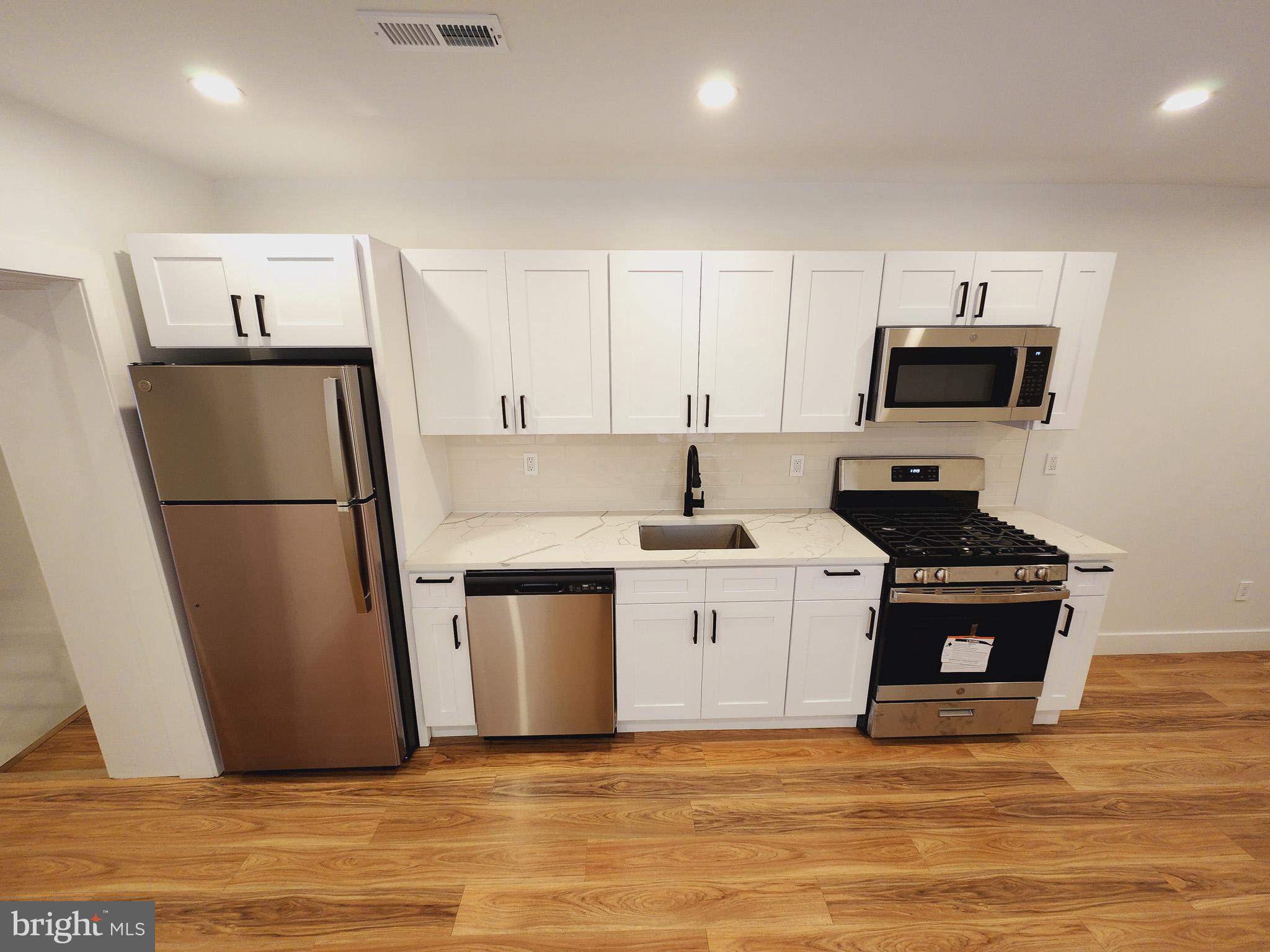 a kitchen with a refrigerator and a stove