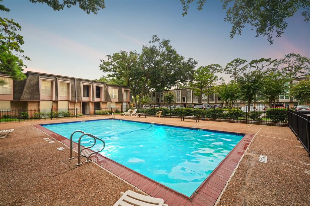 swimming pool view with a seating space