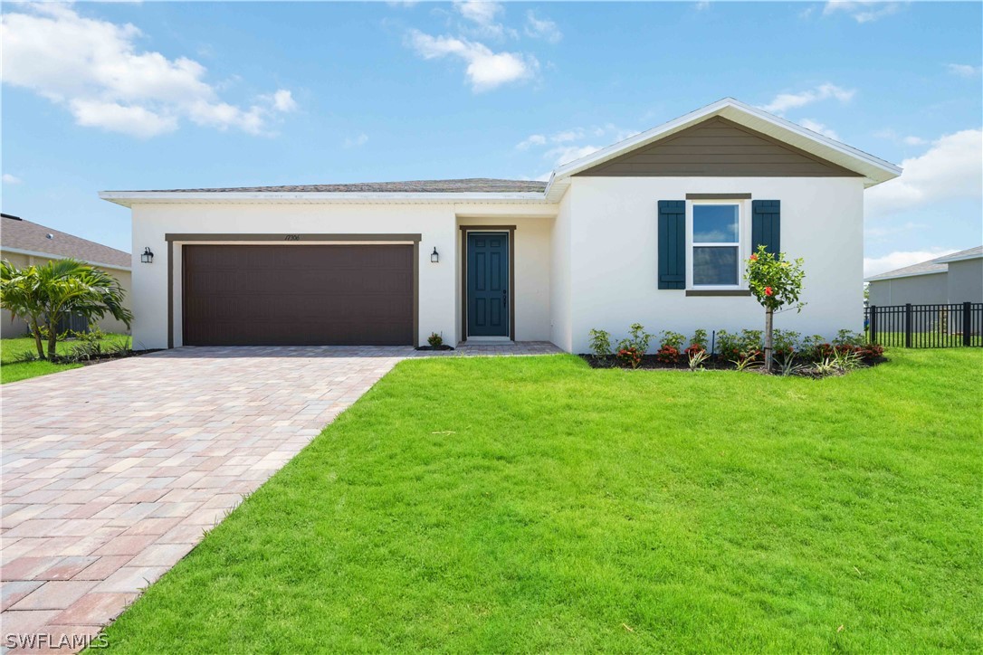 a front view of a house with a yard and garage