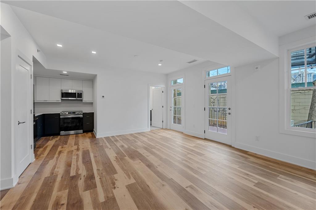 a view of kitchen with granite countertop cabinets and outdoor space