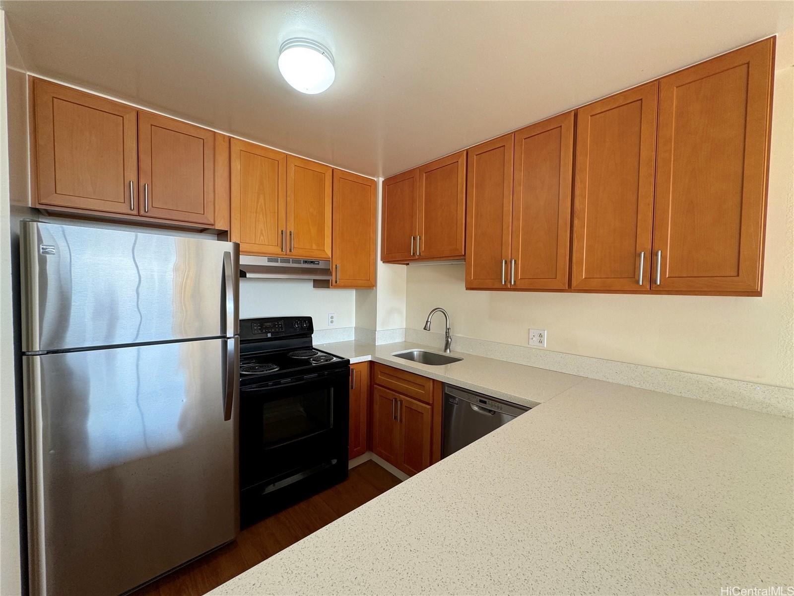 a kitchen with a refrigerator sink and cabinets