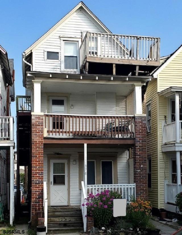 a view of a house with wooden deck