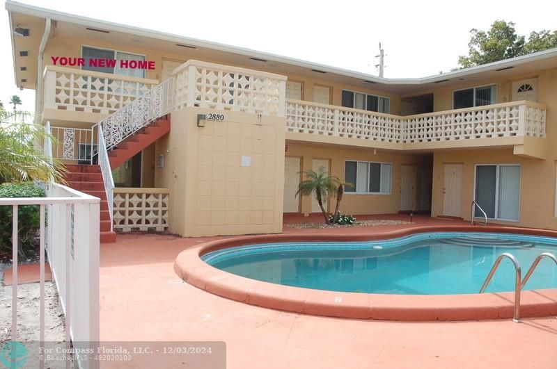 a view of a house with swimming pool and porch