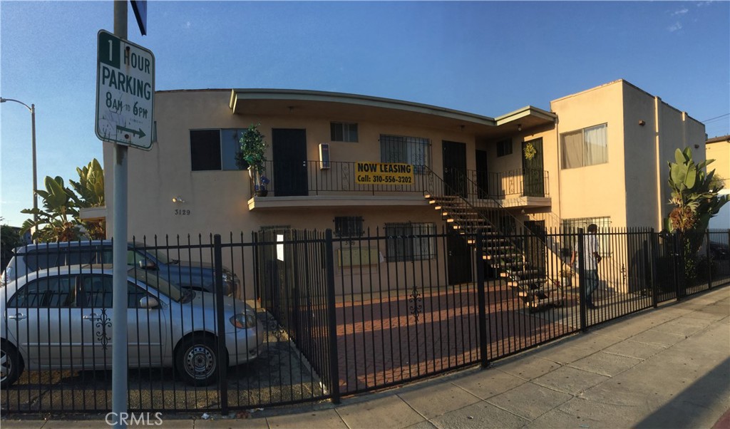 a view of a house with iron fence