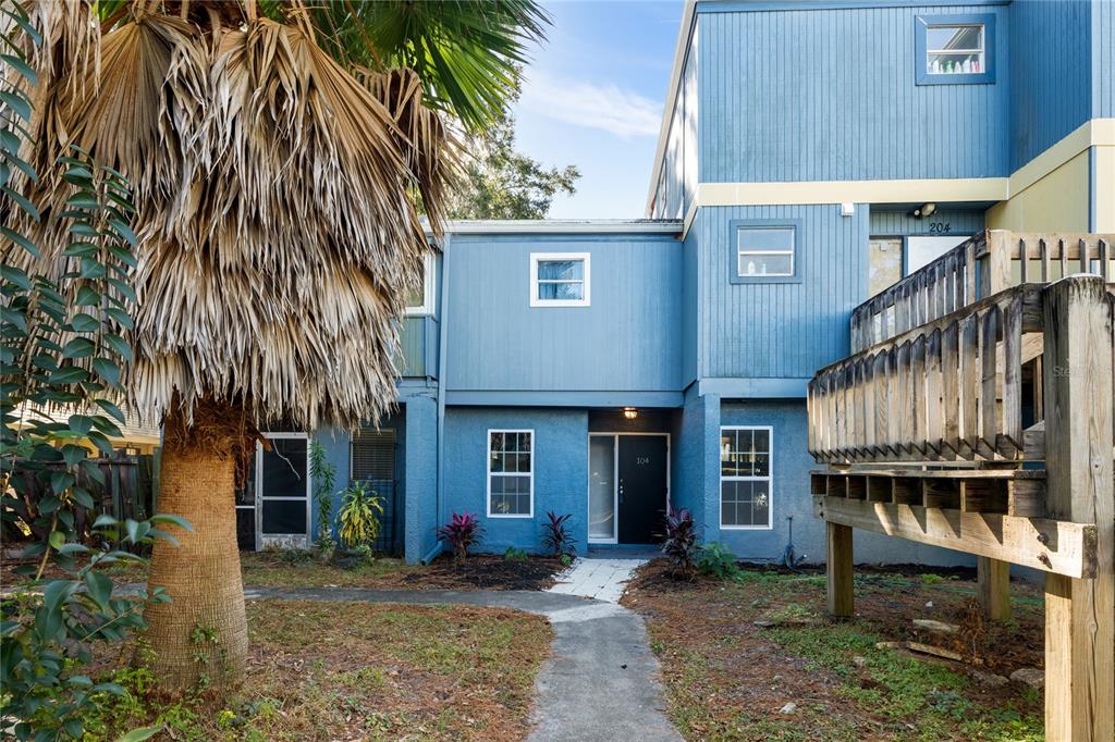 a view of a house with wooden floor next to a yard