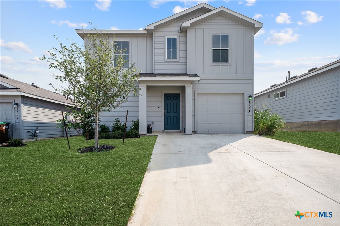 a front view of a house with a yard and garage