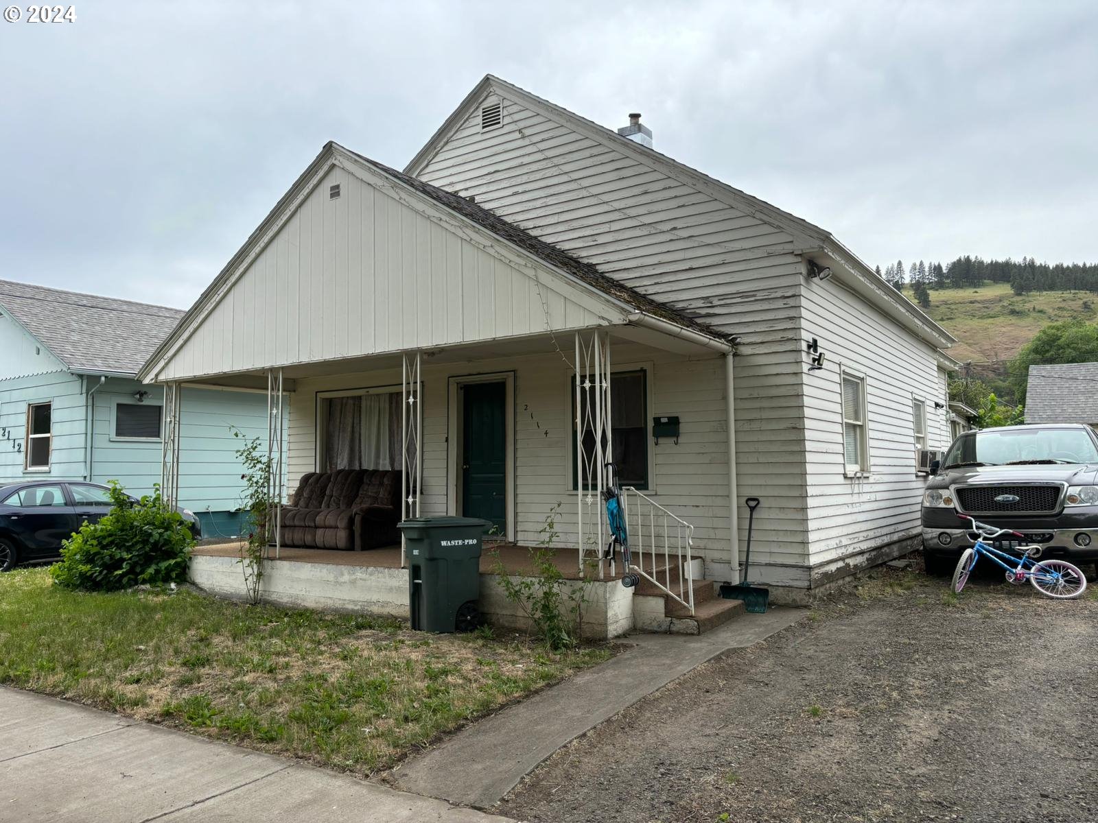 a view of a house with a patio and a yard