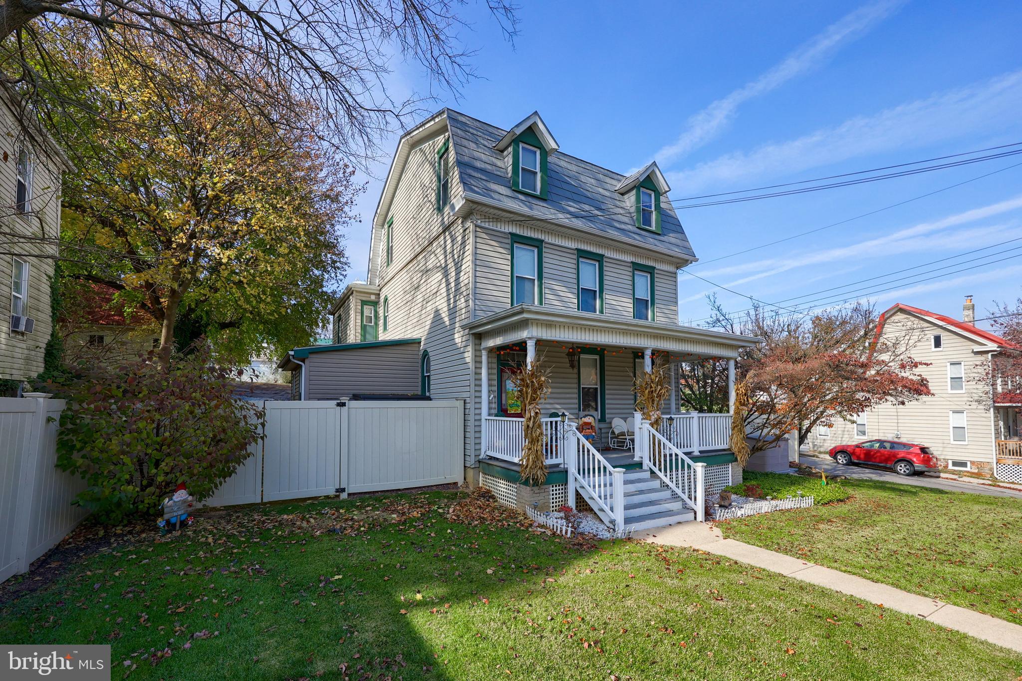 a view of a house with a yard porch and sitting area