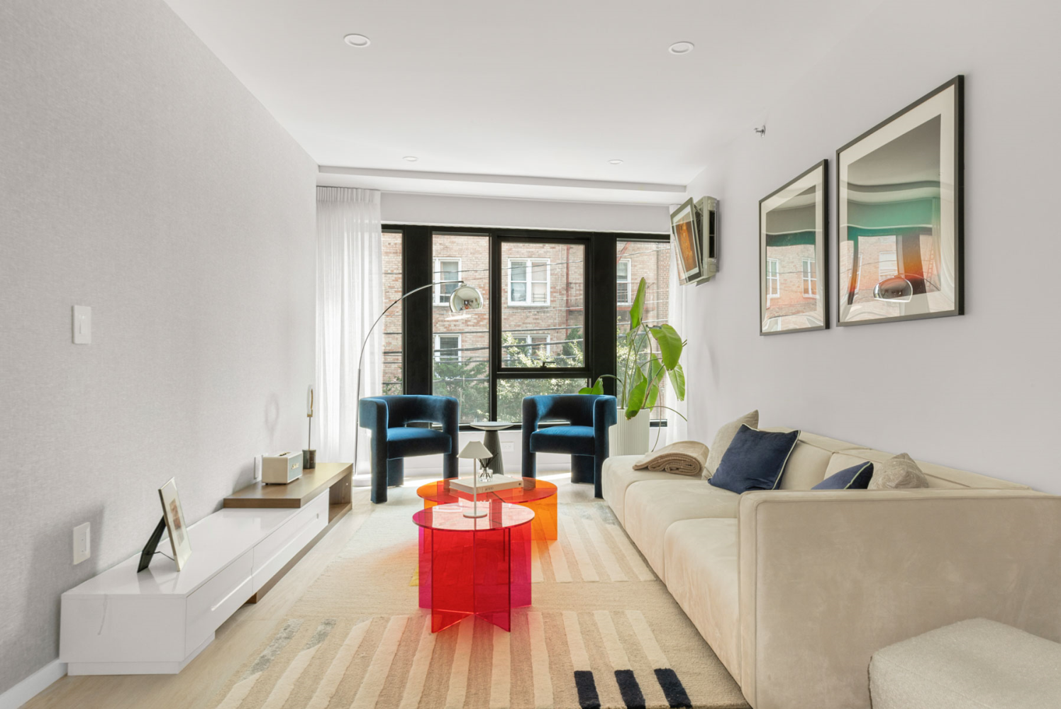 a living room with furniture and floor to ceiling windows