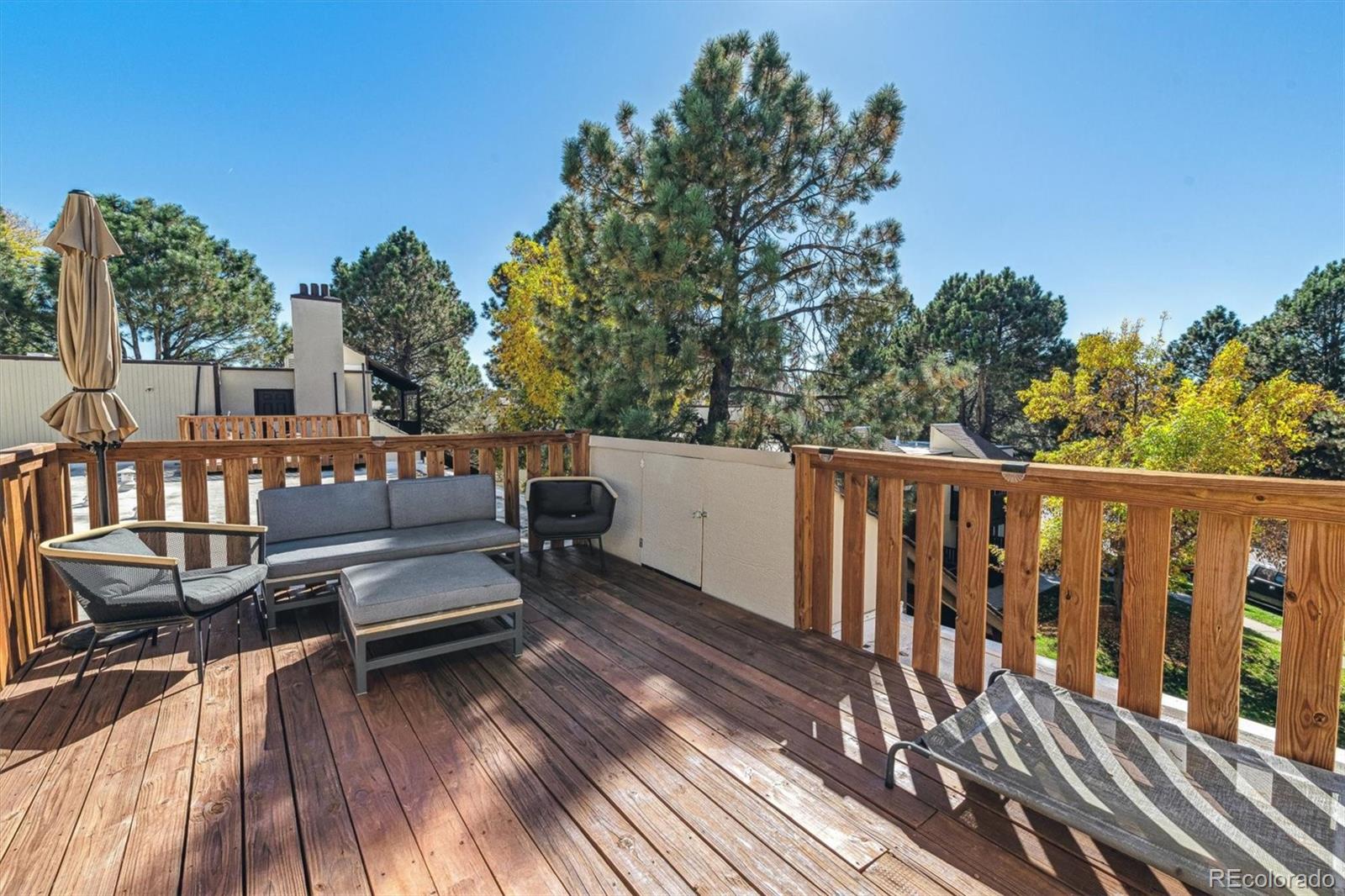 a view of a wooden deck with furniture