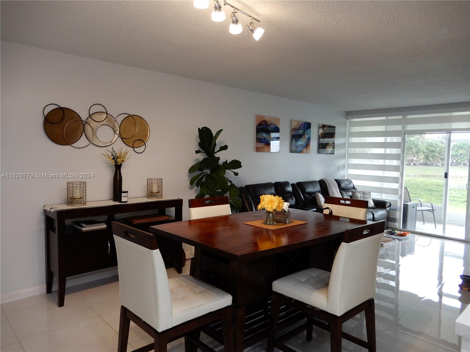 a view of a dining room with furniture and a large window