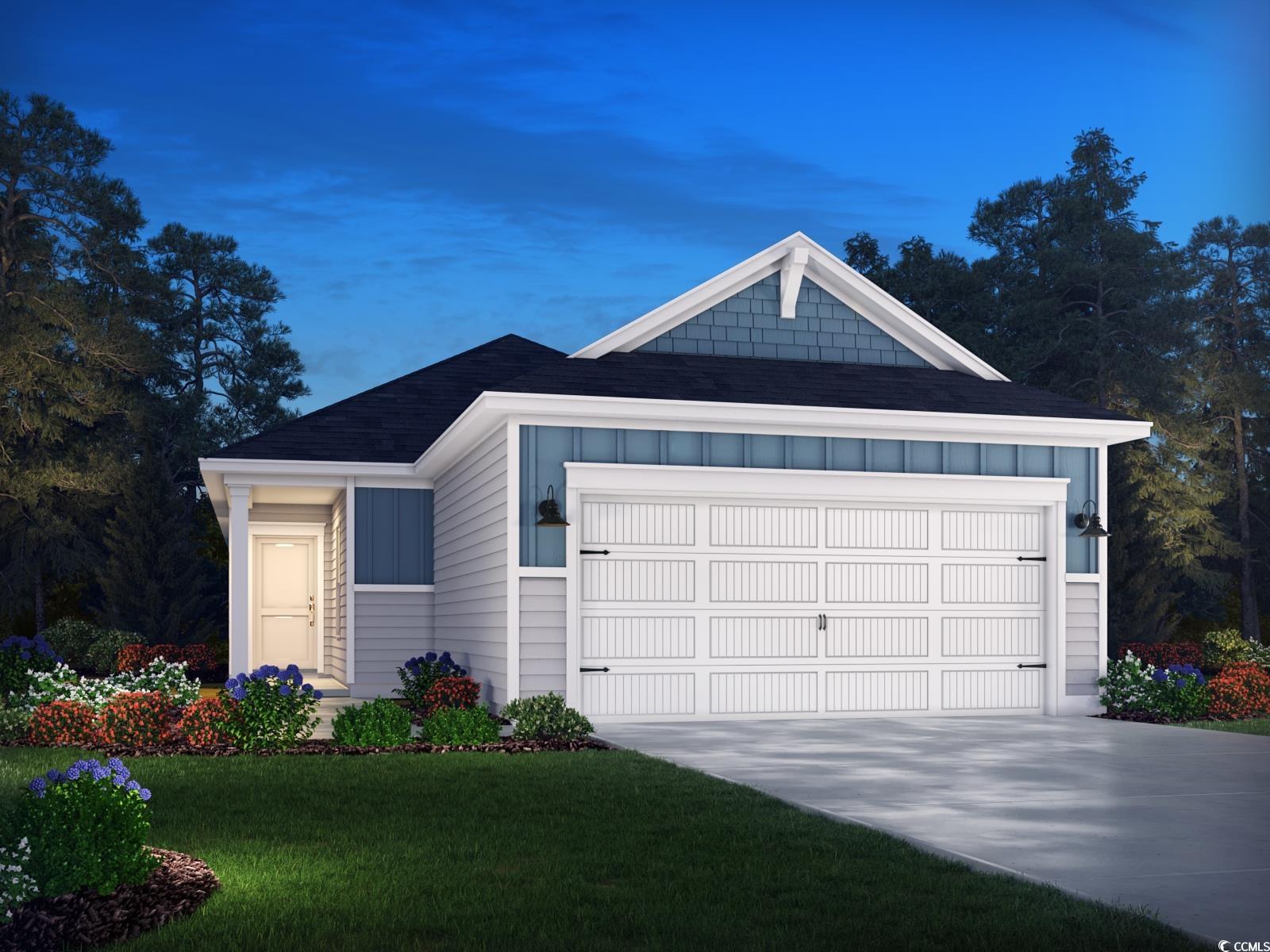 View of front of home with a yard and a garage