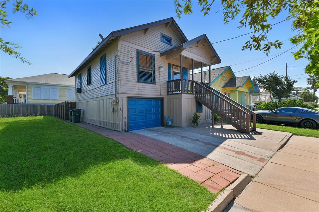 a view of house with backyard and outdoor seating