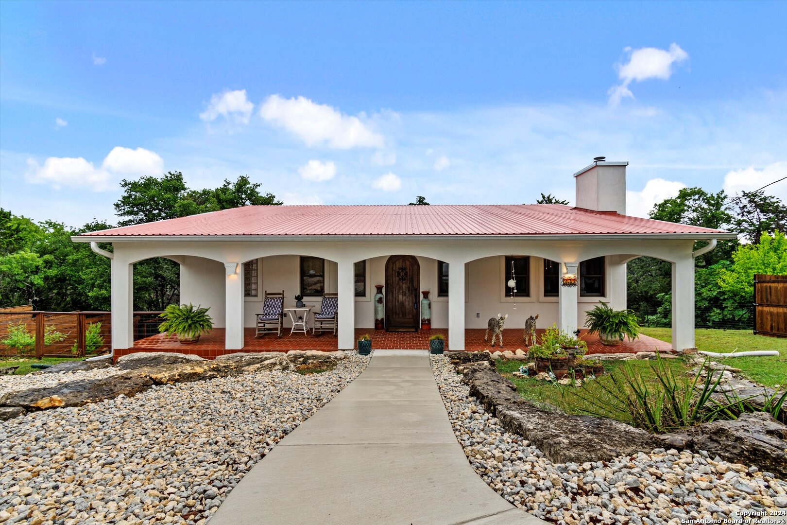 a front view of a house with garden