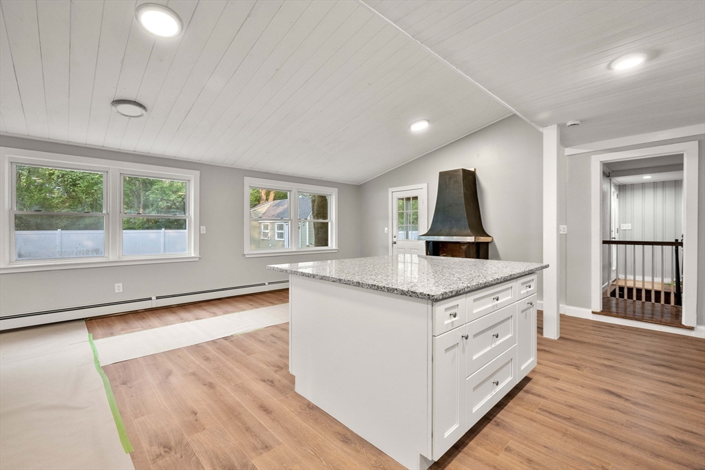 a kitchen with granite countertop a stove and a sink