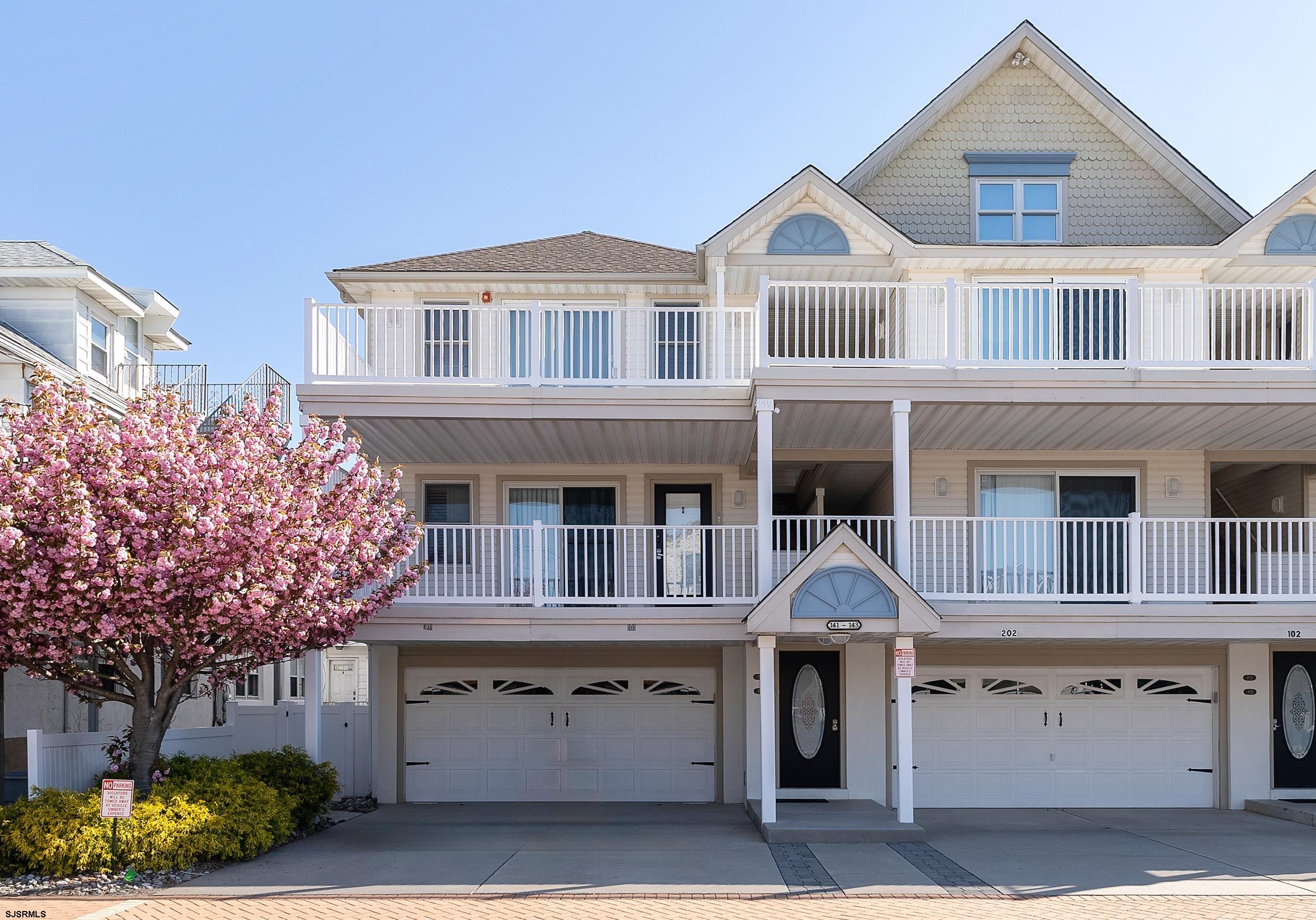 a front view of a residential apartment building with a yard