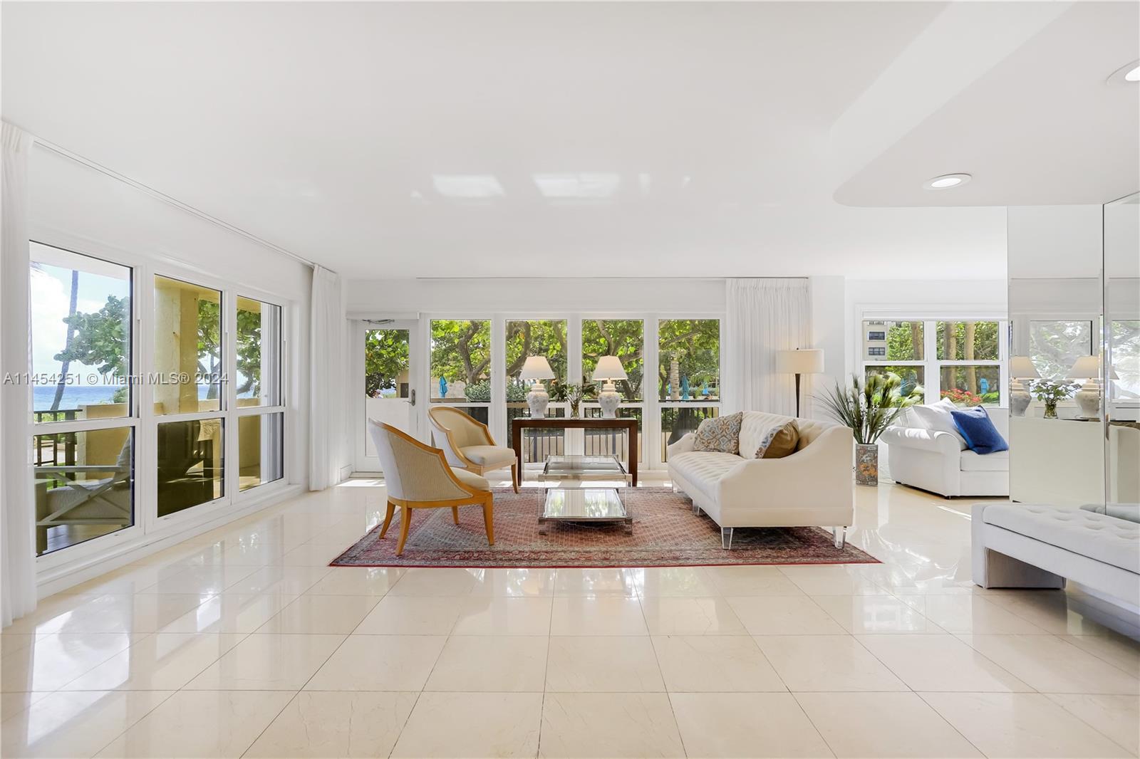 a living room with furniture large window and table