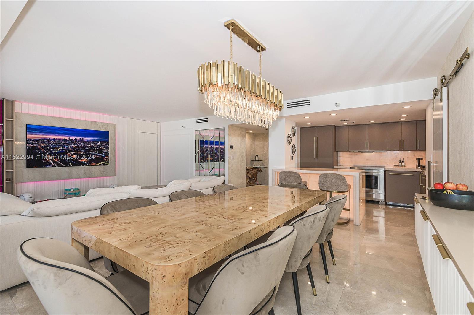 a view of a dining room with furniture and a chandelier