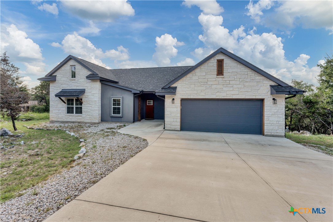 a view of a house with a yard and garage