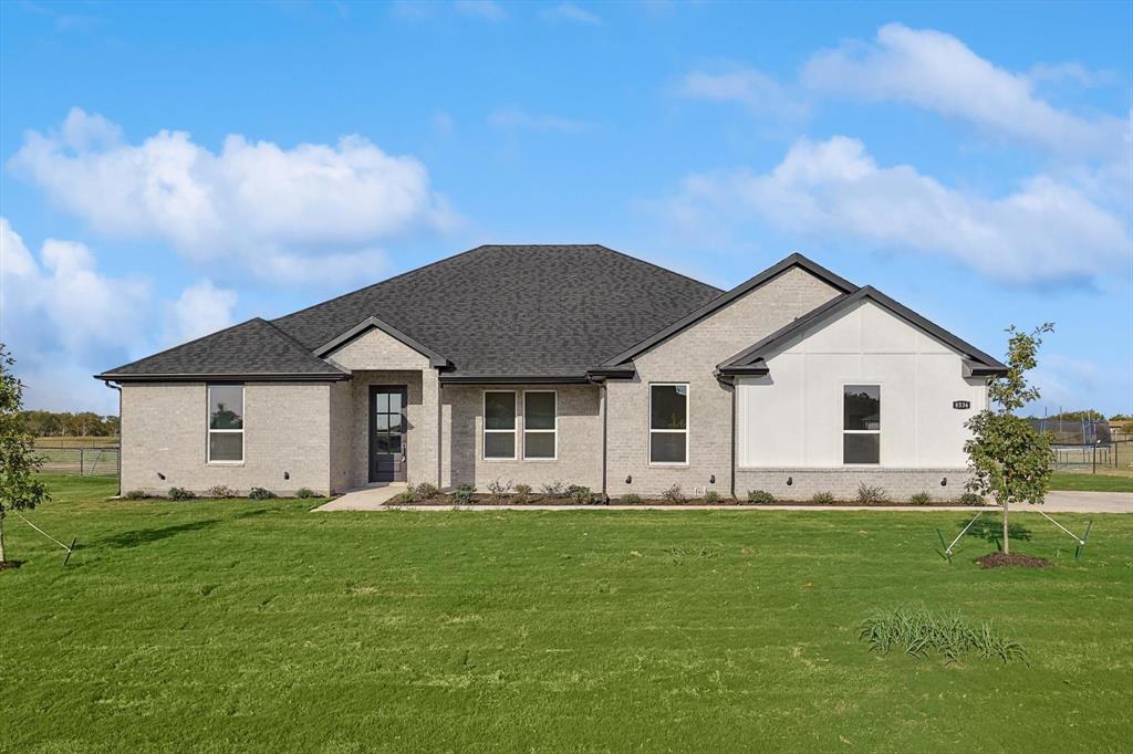 a front view of house with a garden and yard