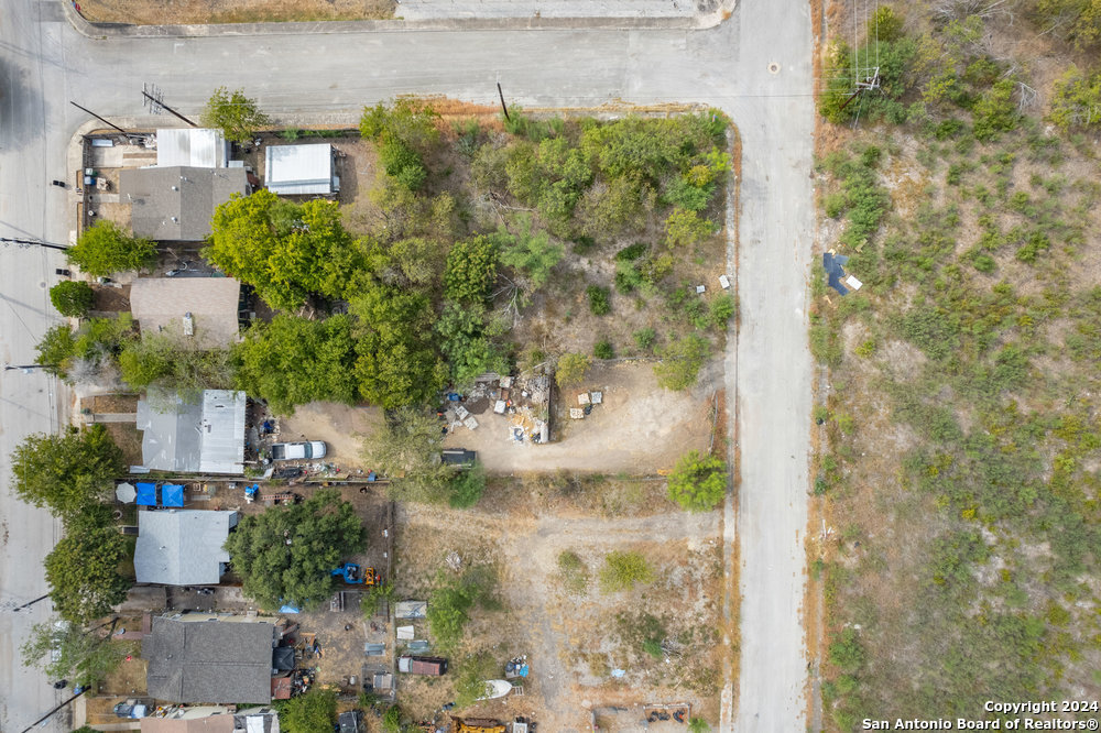 an aerial view of a residential houses with outdoor space