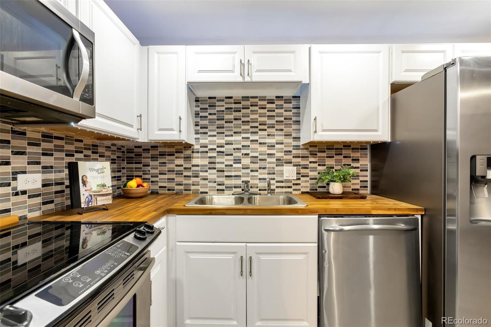 a kitchen with granite countertop a sink and a stove top oven