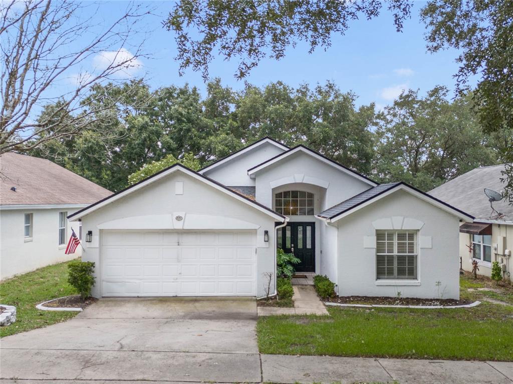 a front view of a house with a yard and garage