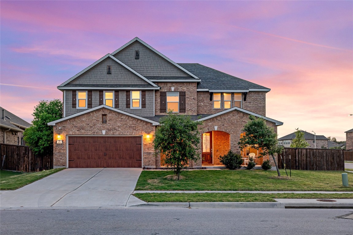 a front view of a house with a yard and garage