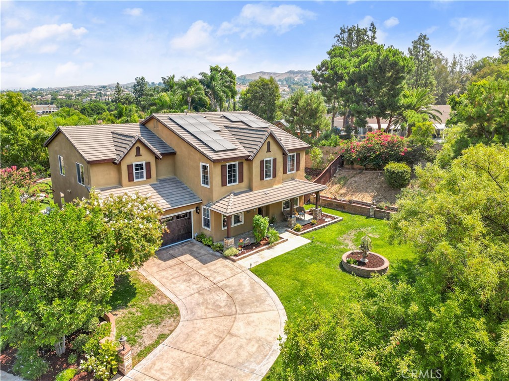 an aerial view of a house with a yard table and chairs