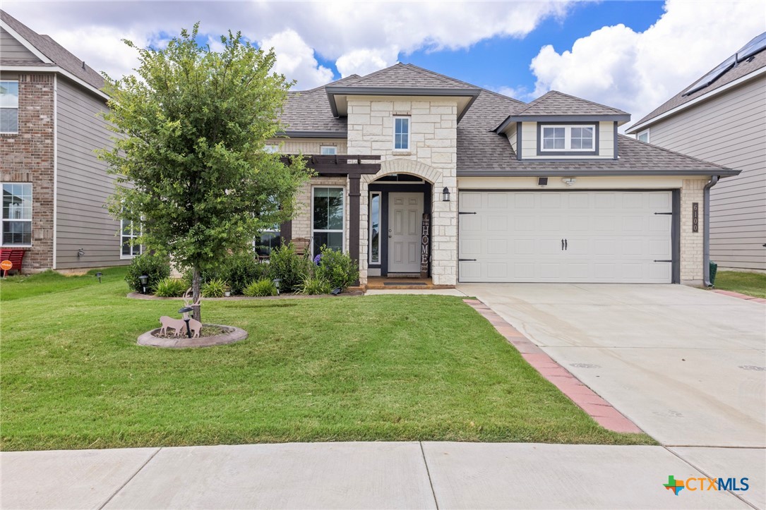 a front view of a house with a yard