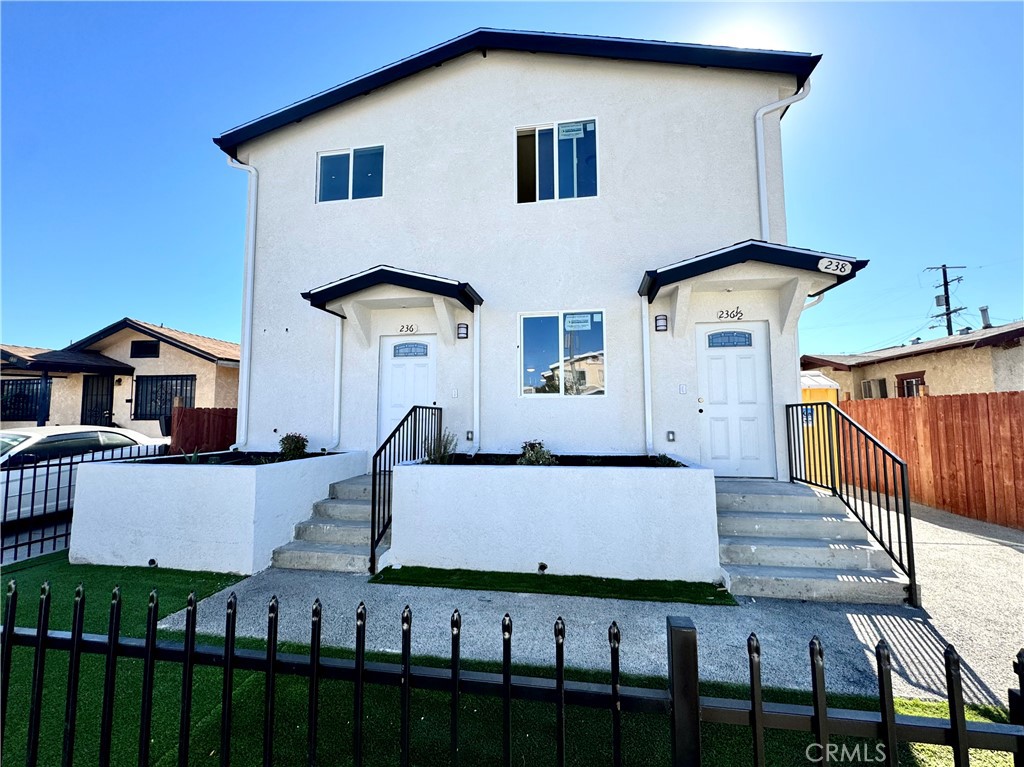 a view of a house with wooden fence