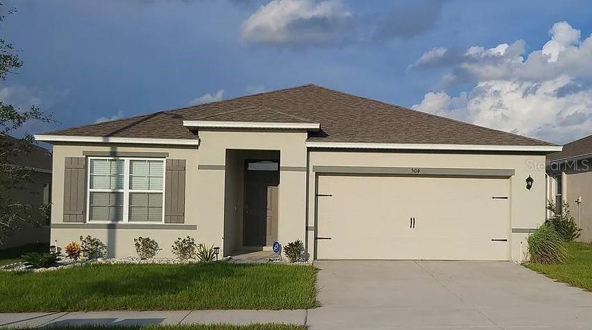 a front view of a house with a yard