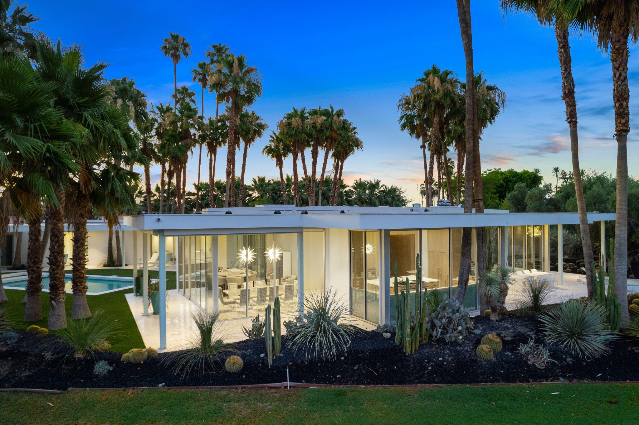 a view of a house with a swimming pool and garden