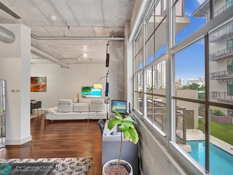 a living room with furniture and a floor to ceiling window