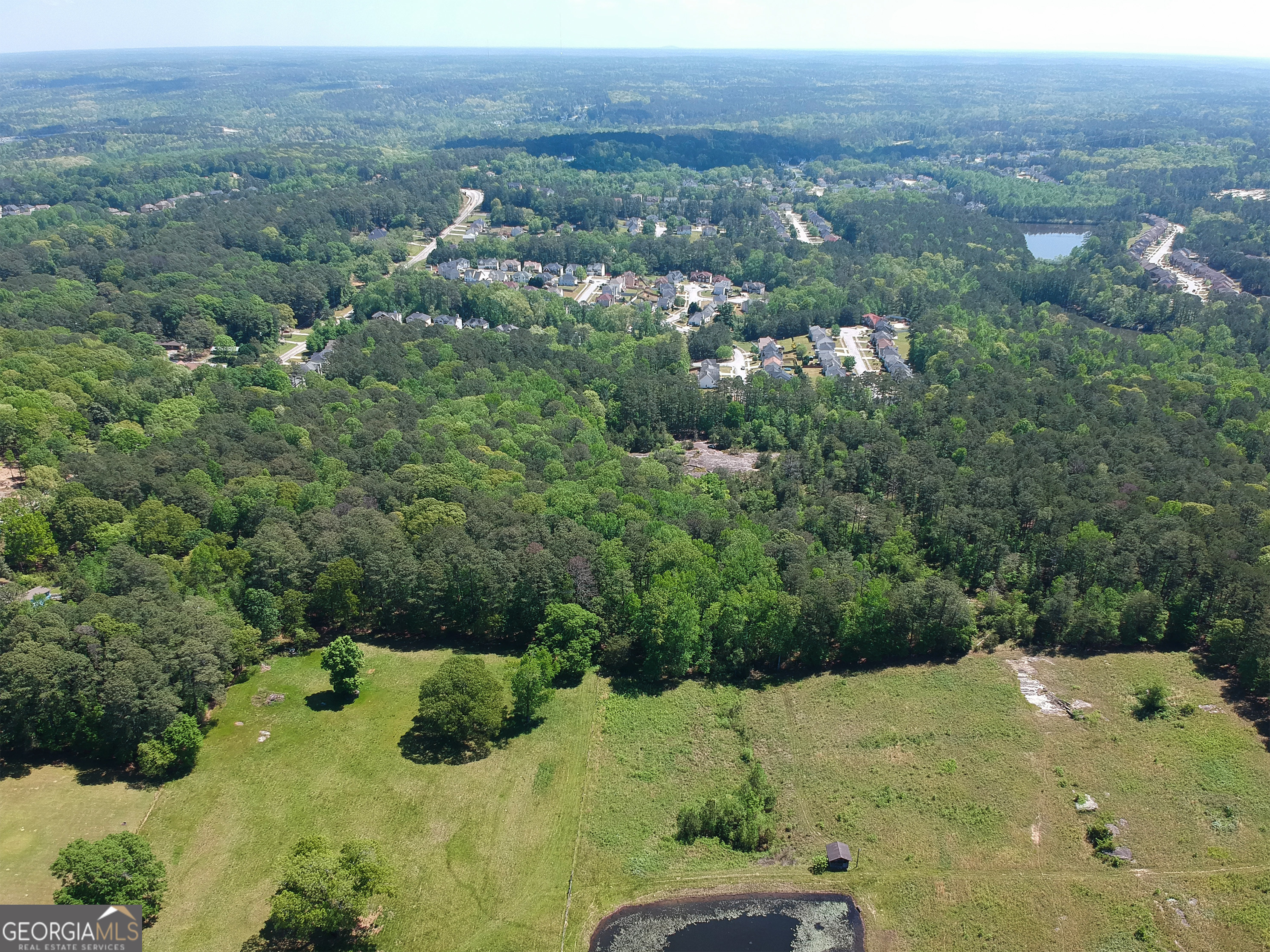 an aerial view of a houses with a yard