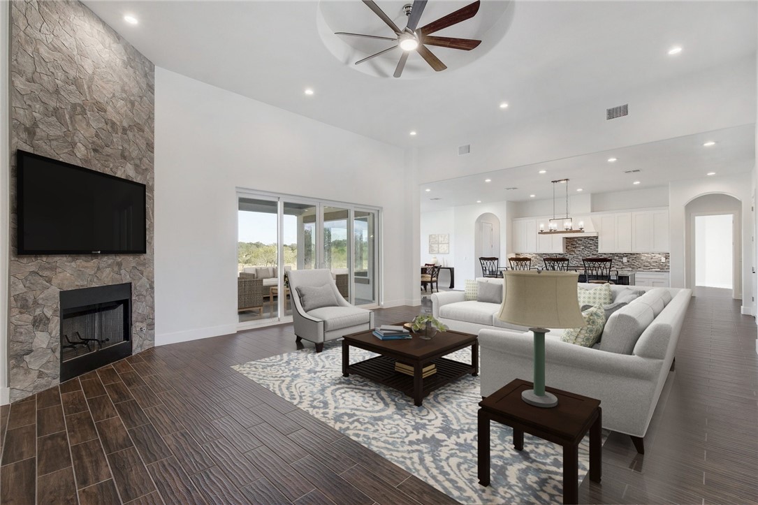 a living room with fireplace furniture and a wooden floor