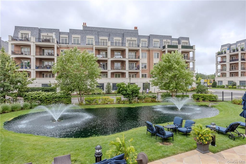 a view of a lake with a residential apartment building in a yard