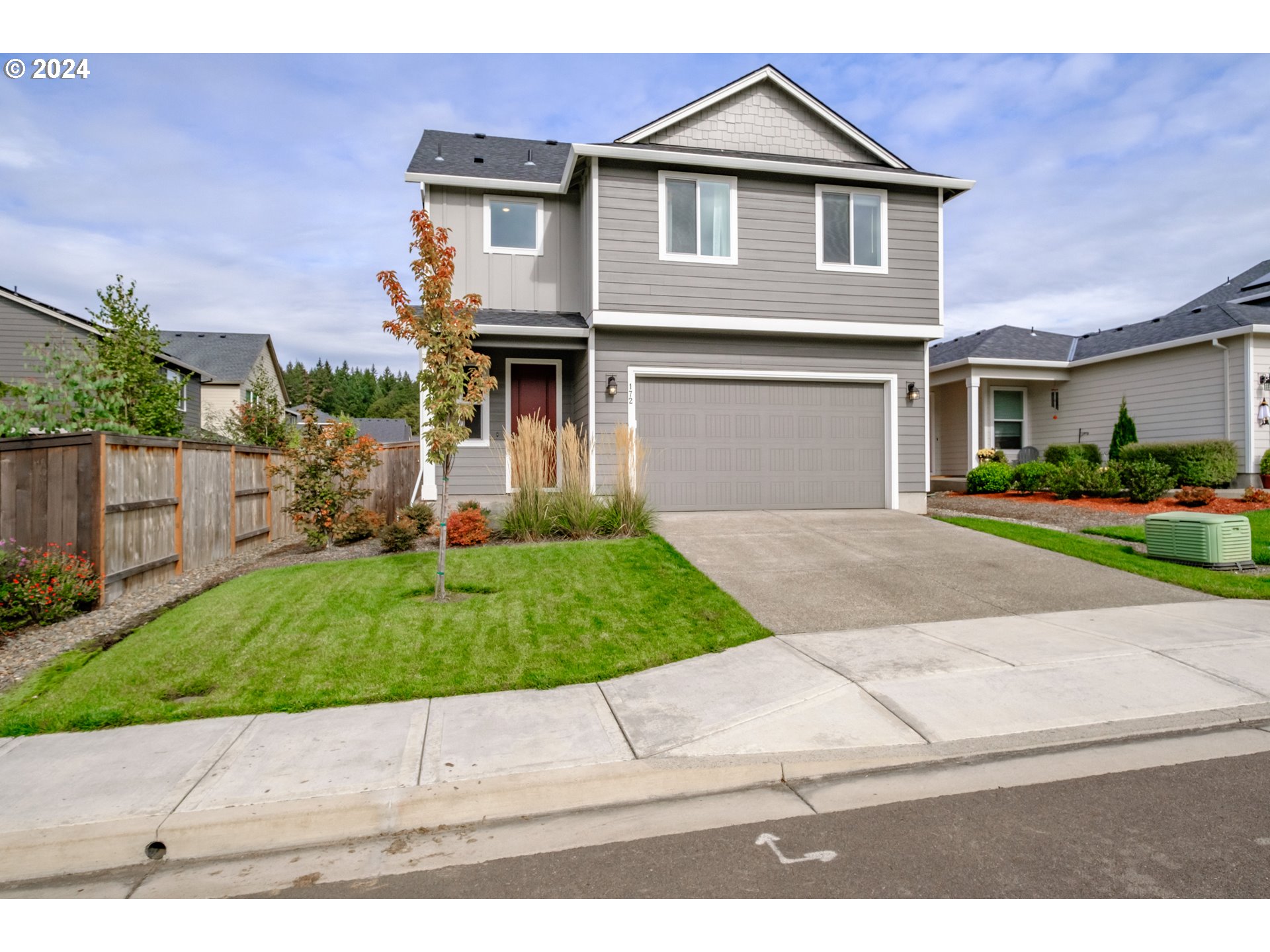 a front view of a house with a yard and a garage