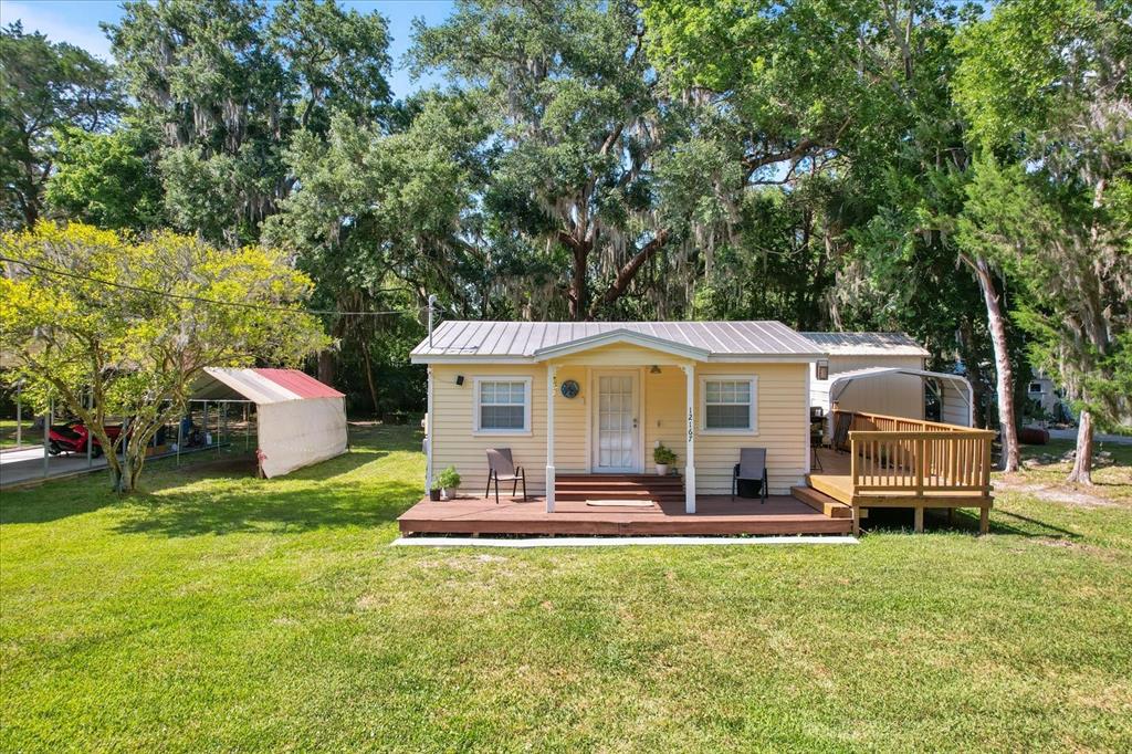 a front view of a house with a yard table and chairs