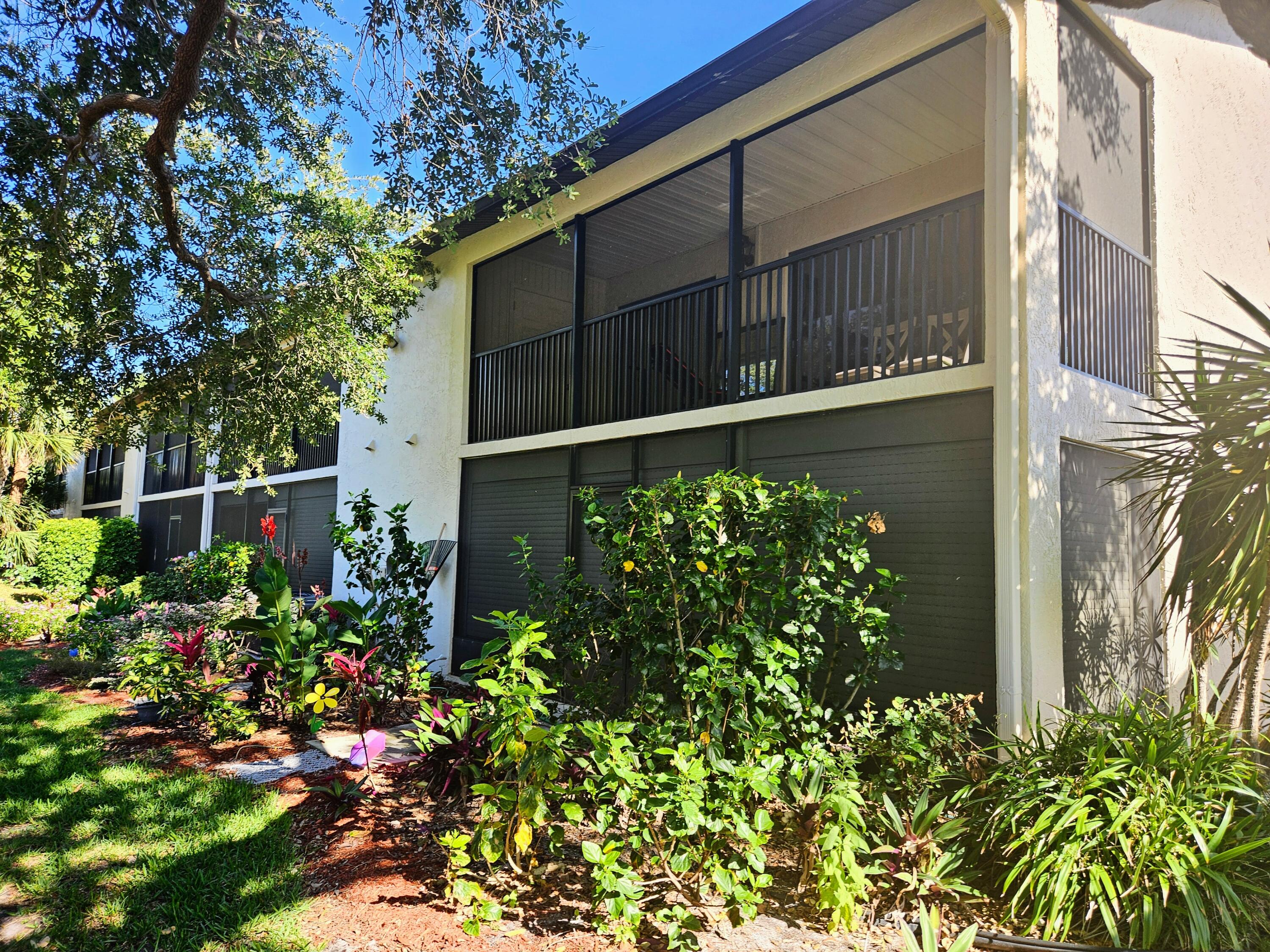 a view of a house with a flower garden