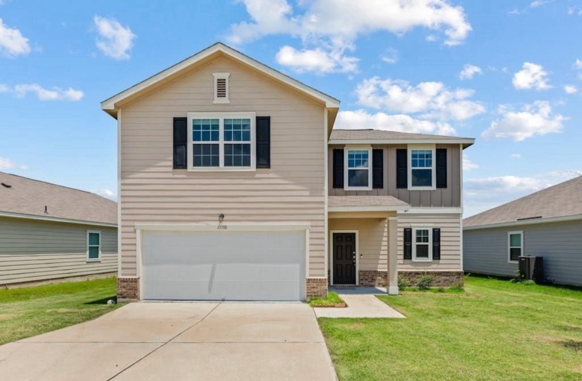 a front view of a house with a yard and garage