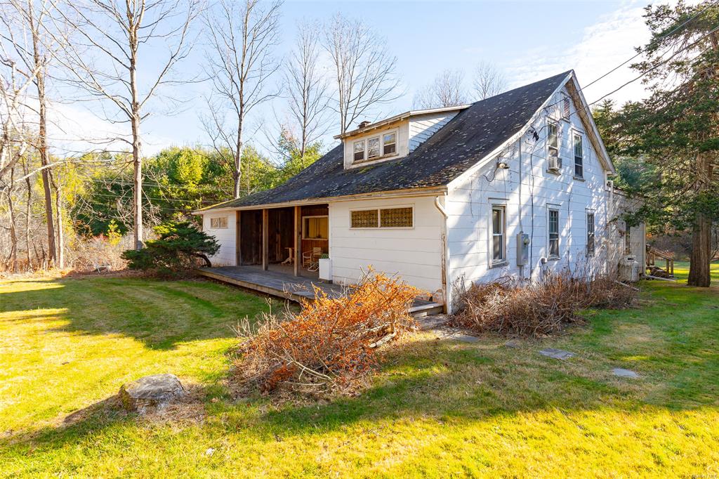 Rear view of property featuring a yard