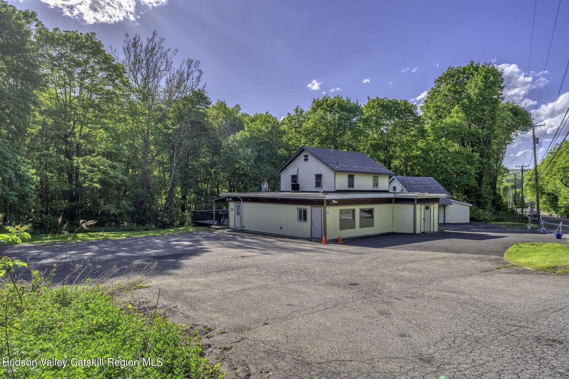 a front view of a house with a yard and trees